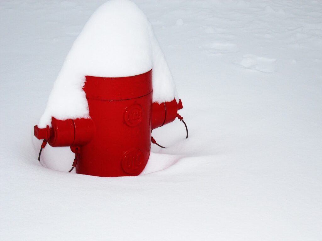 Fire hydrant half covered in snow